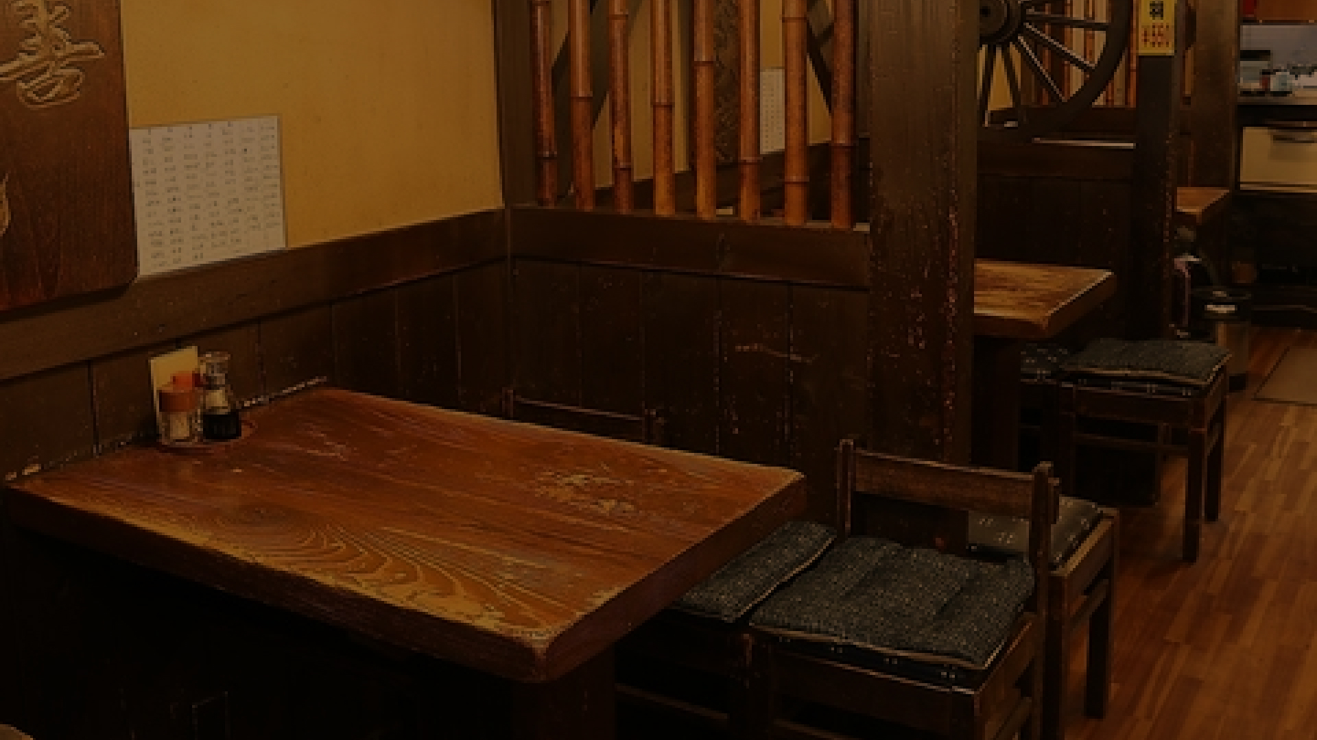 木製のテーブルと椅子が配置された、和レトロな雰囲気の店内 PC